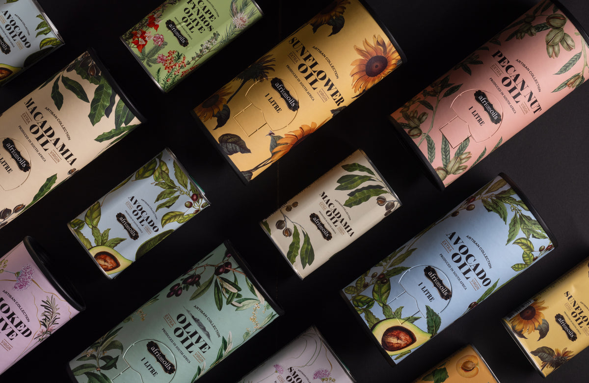 African Oils Artisan Collection tins laid out: macadamia, sunflower, pecan nut, avocado and olive oil